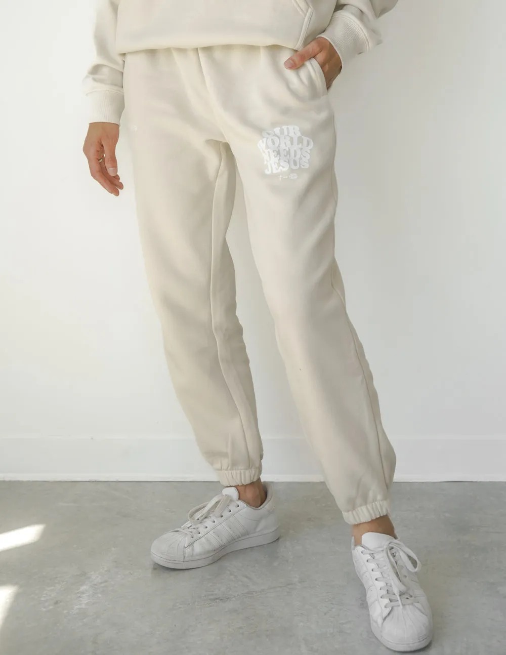 Our World Needs Jesus Beige Unisex Sweatpant