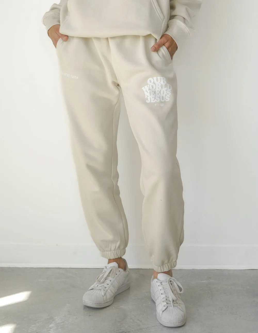 Our World Needs Jesus Beige Unisex Sweatpant